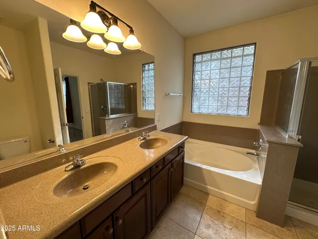 a bathroom with a double vanity sink and a mirror