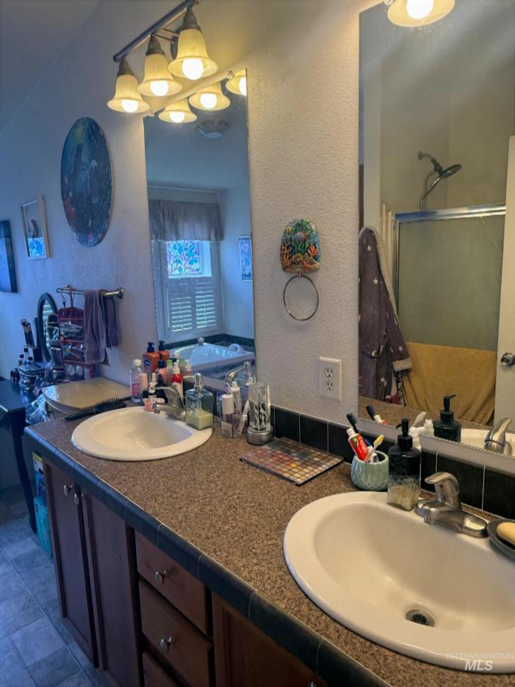 100 Ellsworth Street Vale, OR 97918 - Photo 13 of 25 Bathroom featuring a double vanity with wood cabinetry and a speckled countertop