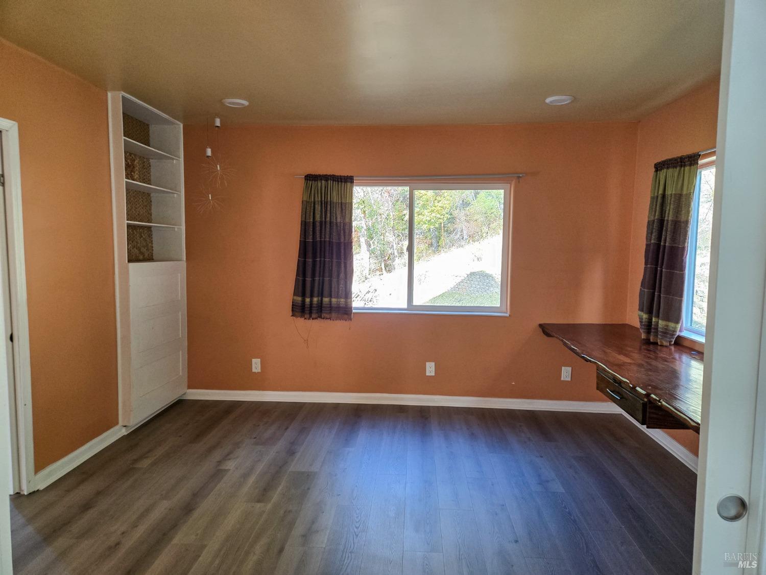47111 Fox Rock Road Laytonville, CA 95454 - Photo 12 of 44 an empty room with wooden floor and windows