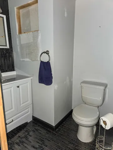 a white toilet sitting next to a bathroom sink