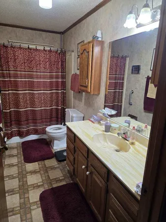a kitchen with granite countertop a sink cabinets and stainless steel appliances