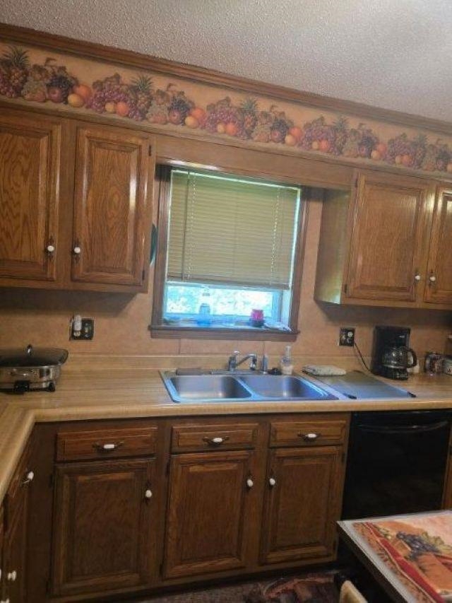2902 Arp Central Road Ripley, TN 38063 - Photo 12 of 14 a kitchen with granite countertop a sink cabinets and stainless steel appliances