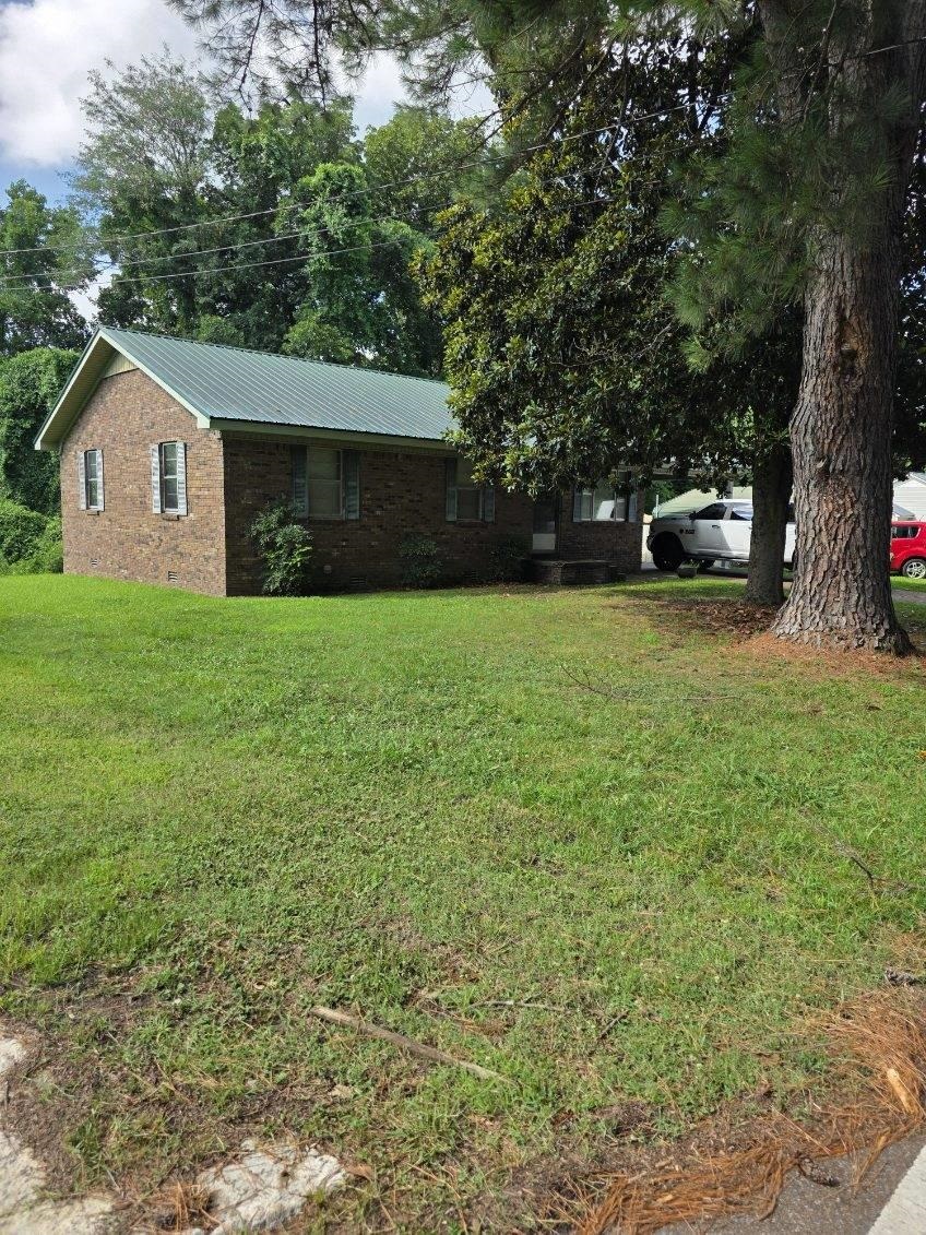 2902 Arp Central Road Ripley, TN 38063 - Photo 2 of 14 a yellow house sitting in middle of the forest