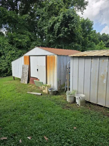 a backyard of a house with lawn chairs and wooden fence