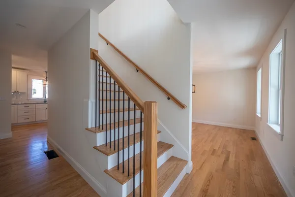 a view of entryway with wooden floor and stairs