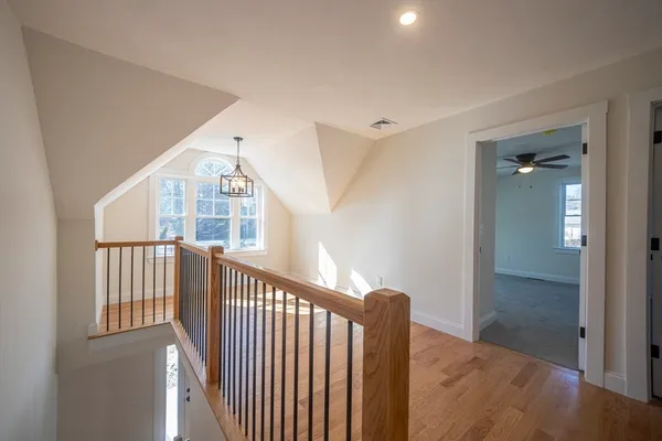a view of staircase with railing and a chandelier