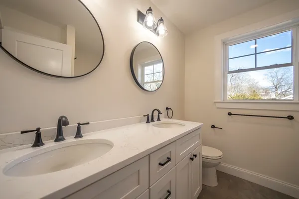 a bathroom with a toilet a sink and a mirror