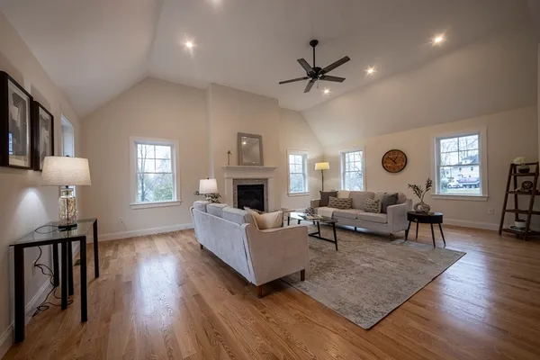 a living room with furniture and a wooden floor