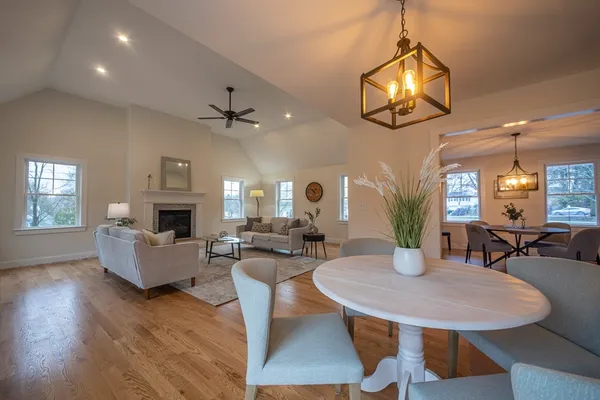 a living room with fireplace furniture and a wooden floor