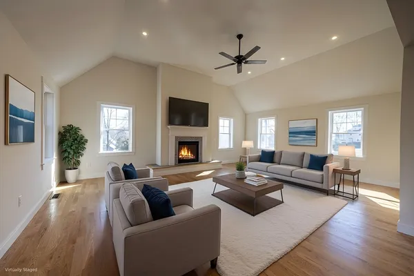 a living room with furniture fireplace and a window