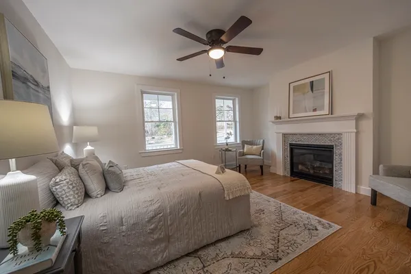 a bedroom with a large bed and a fireplace