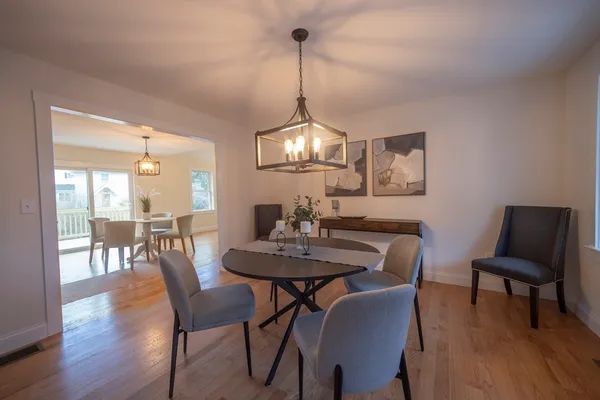 a view of a dining room with furniture window and wooden floor