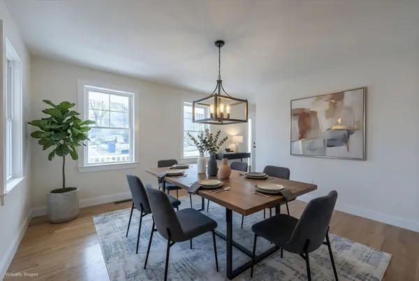 a view of a dining room with furniture window and wooden floor
