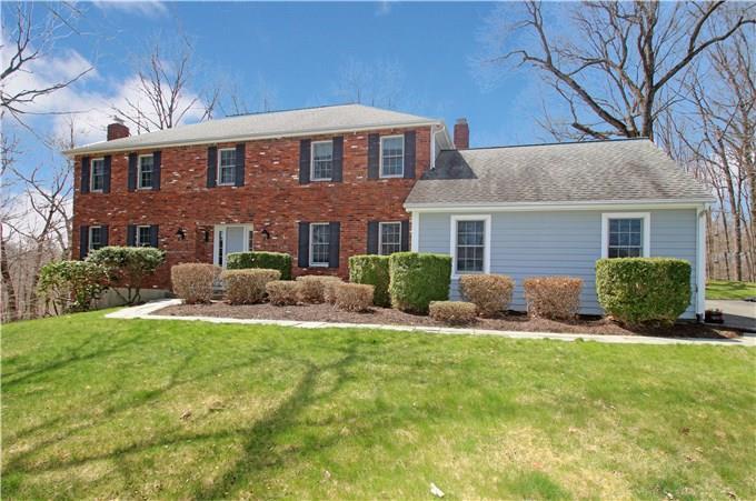 105 11 Levels Road Ridgefield, CT 06877 - Photo 1 of 1 a front view of a house with a yard and garage