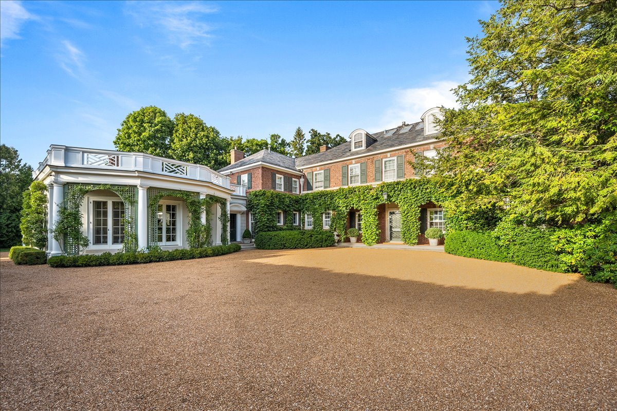 a view of a house with a yard and potted plants