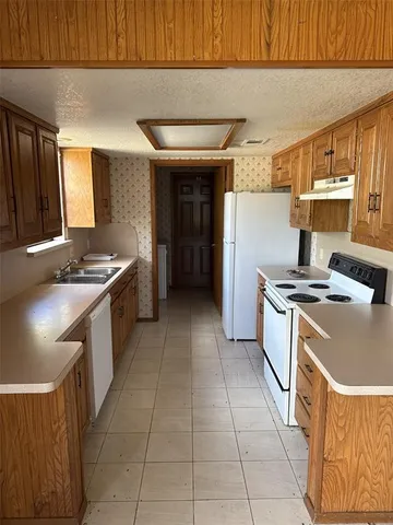 a kitchen with a stove and a refrigerator