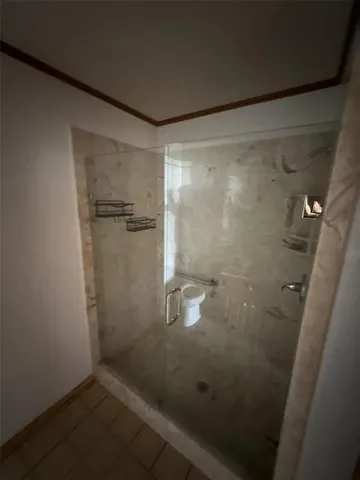 a bathroom with a glass shower door