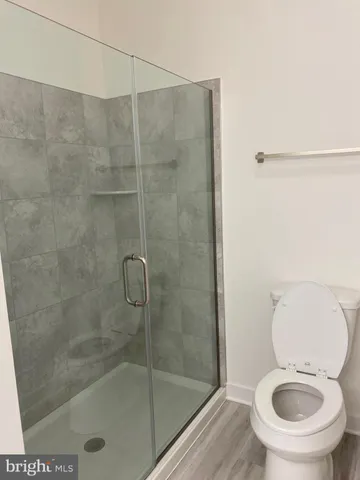 a bathroom with a toilet and a shower