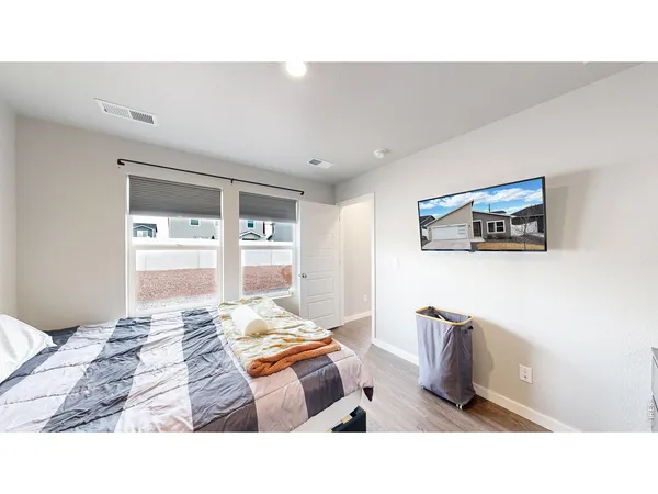 a living room with a bed furniture and next to a window