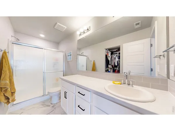 a bathroom with a sink double vanity and a mirror