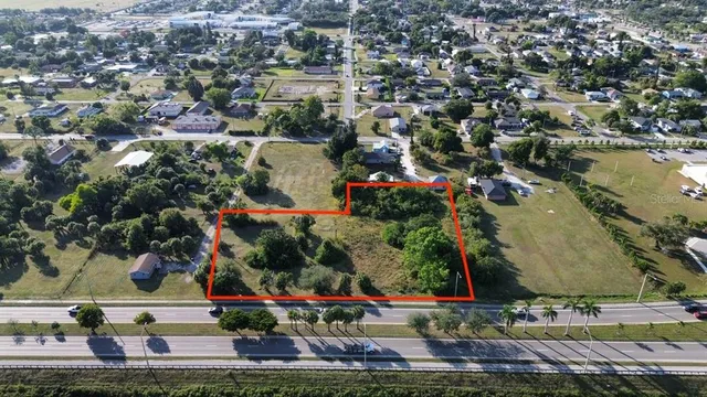 an aerial view of residential houses with outdoor space and swimming pool