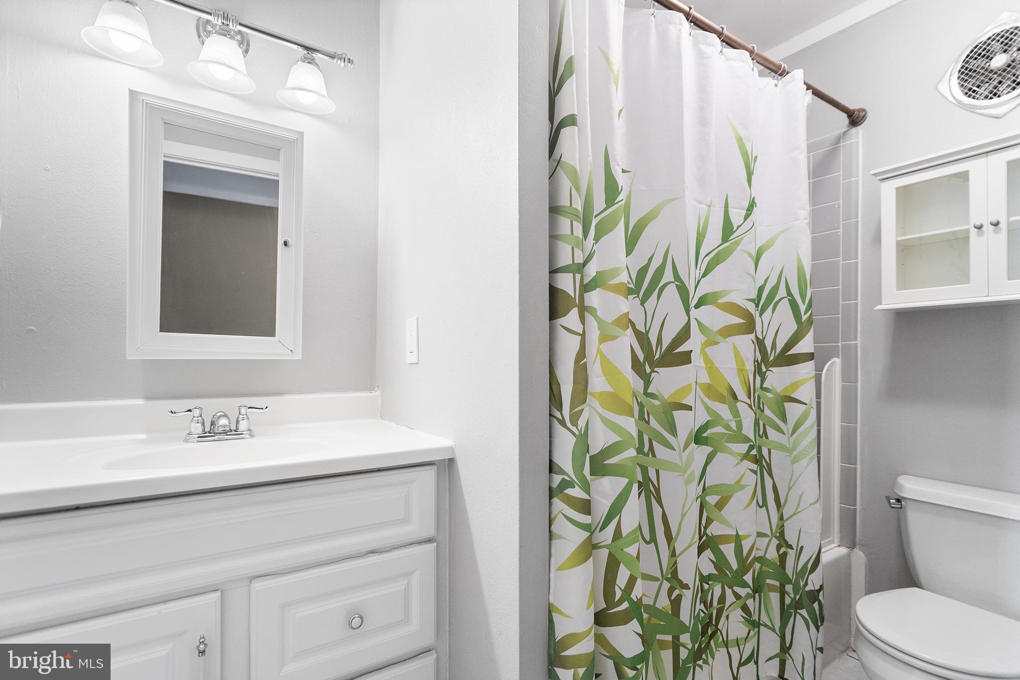 625 Summit House West Chester, PA 19382 - Photo 11 of 16 a bathroom with a sink a toilet and a mirror