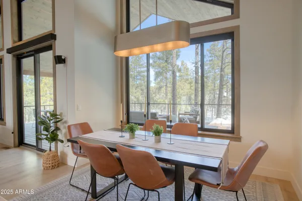 a dining room with furniture window and wooden floor