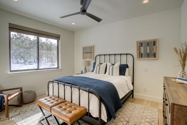 a bedroom with a bed next to a window