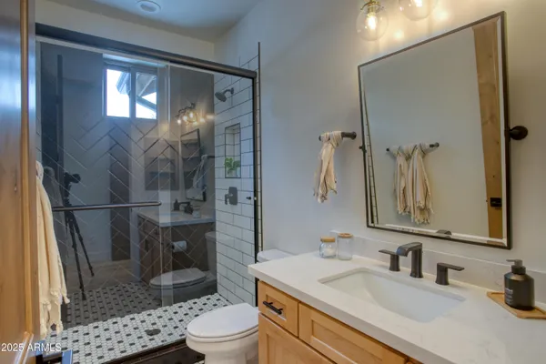 a bathroom with a sink toilet and shower