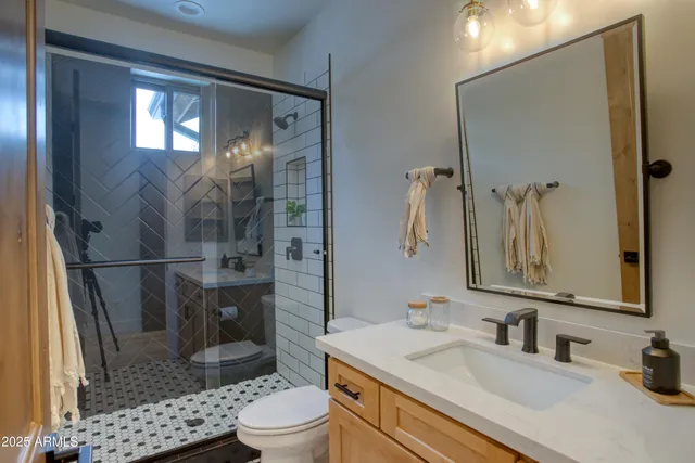 a bathroom with a sink toilet and shower