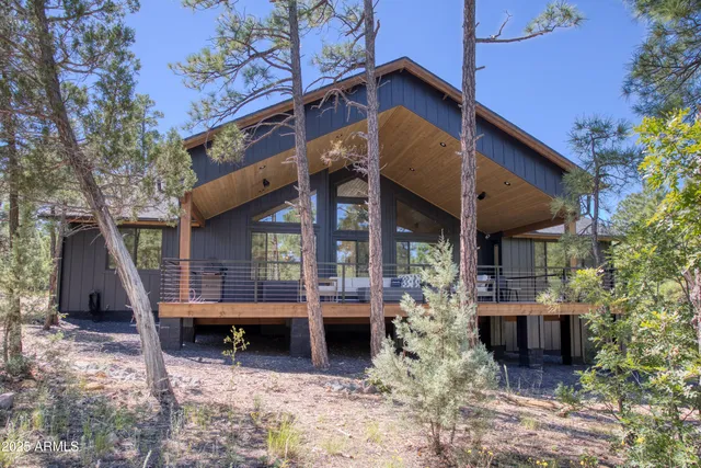 a view of a house with a balcony and wooden fence