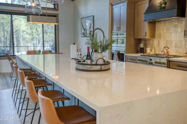 a dining room with furniture and a large window