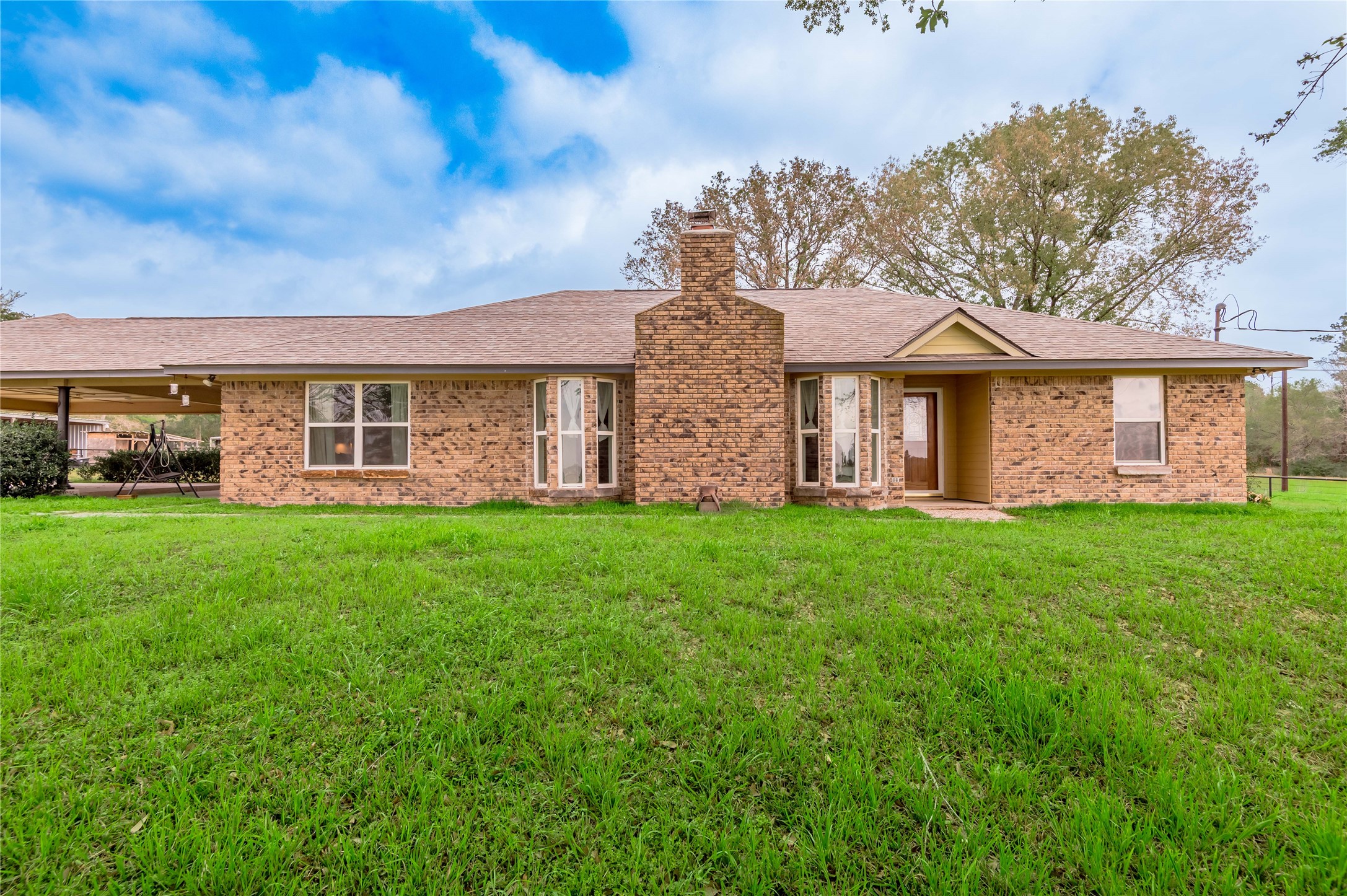 758 Wire Road Huntsville, TX 77320 - Photo 2 of 44 a front view of a house with a yard