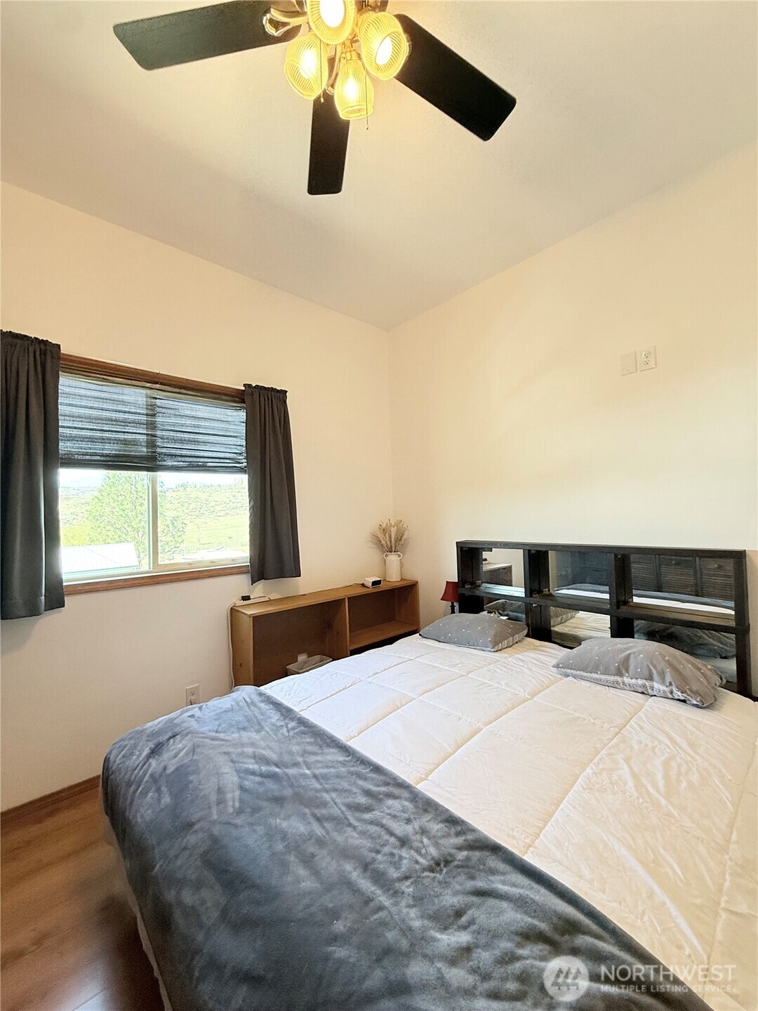 63 Shumway Road Omak, WA 98841 - Photo 14 of 39 a bedroom with a large bed and a large window