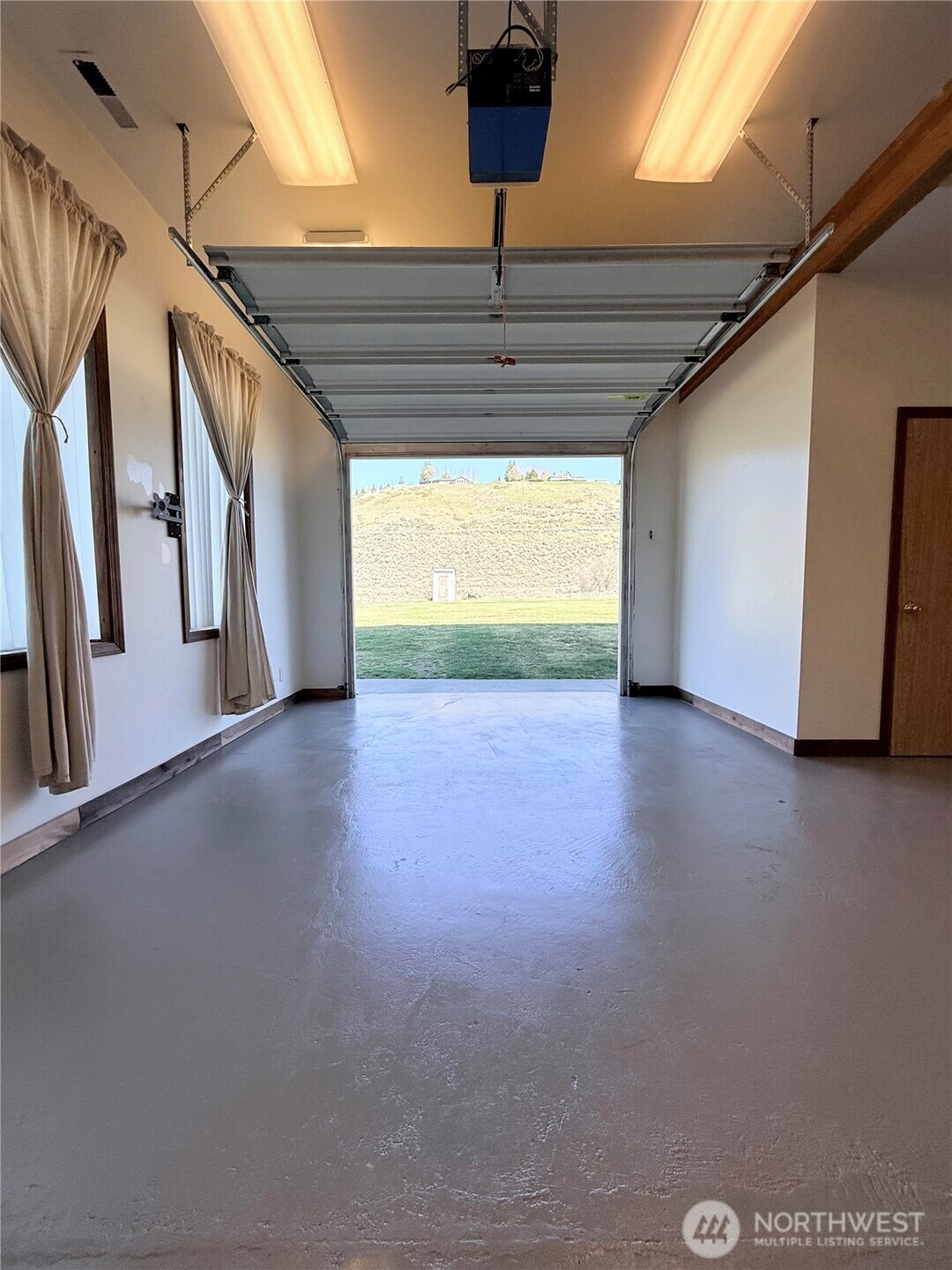 63 Shumway Road Omak, WA 98841 - Photo 21 of 39 a view of an empty room with window and wooden floor