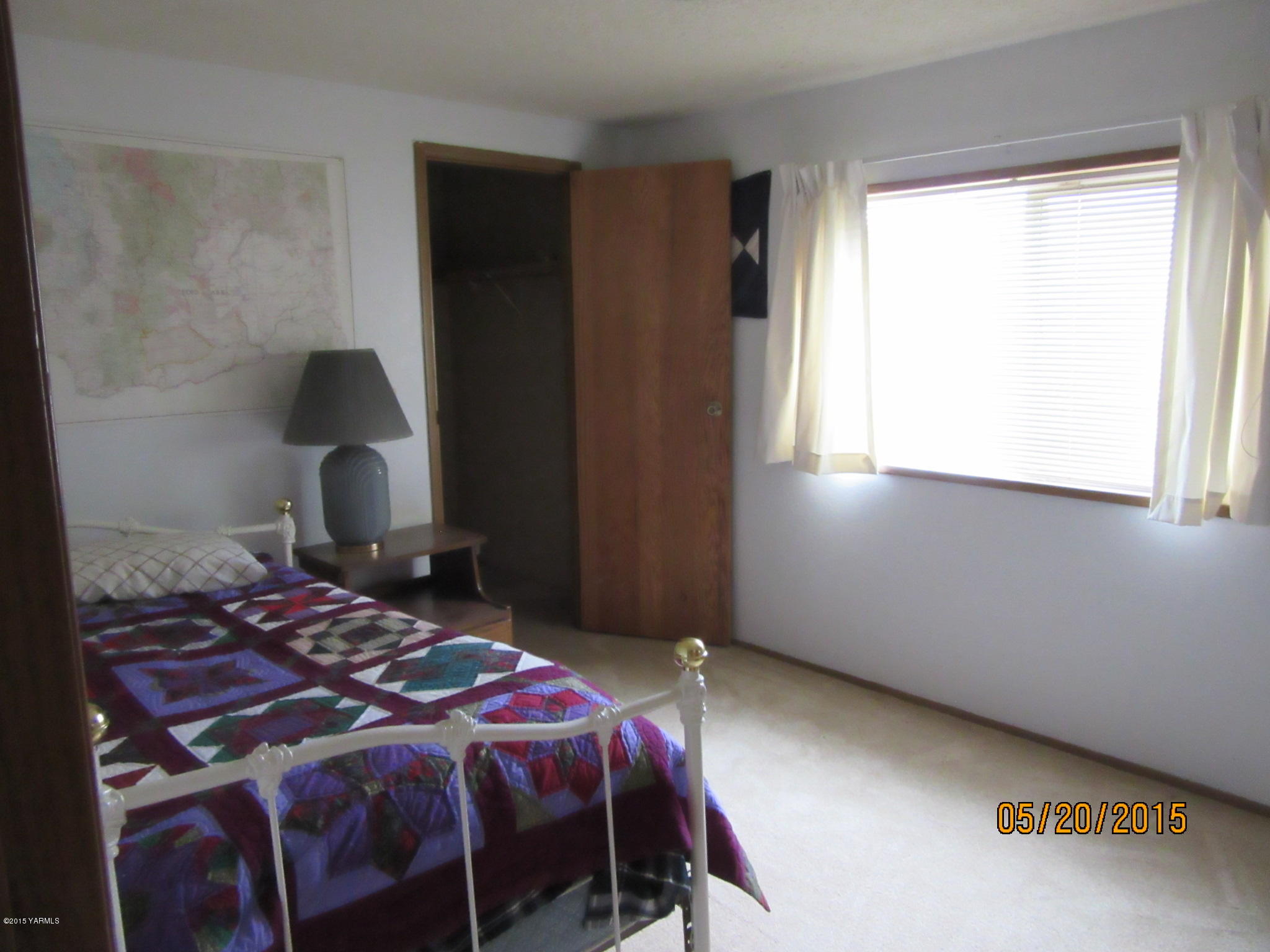 1510 Gurley Road Granger, WA 98932 - Photo 22 of 29 a bedroom with a bed and a window