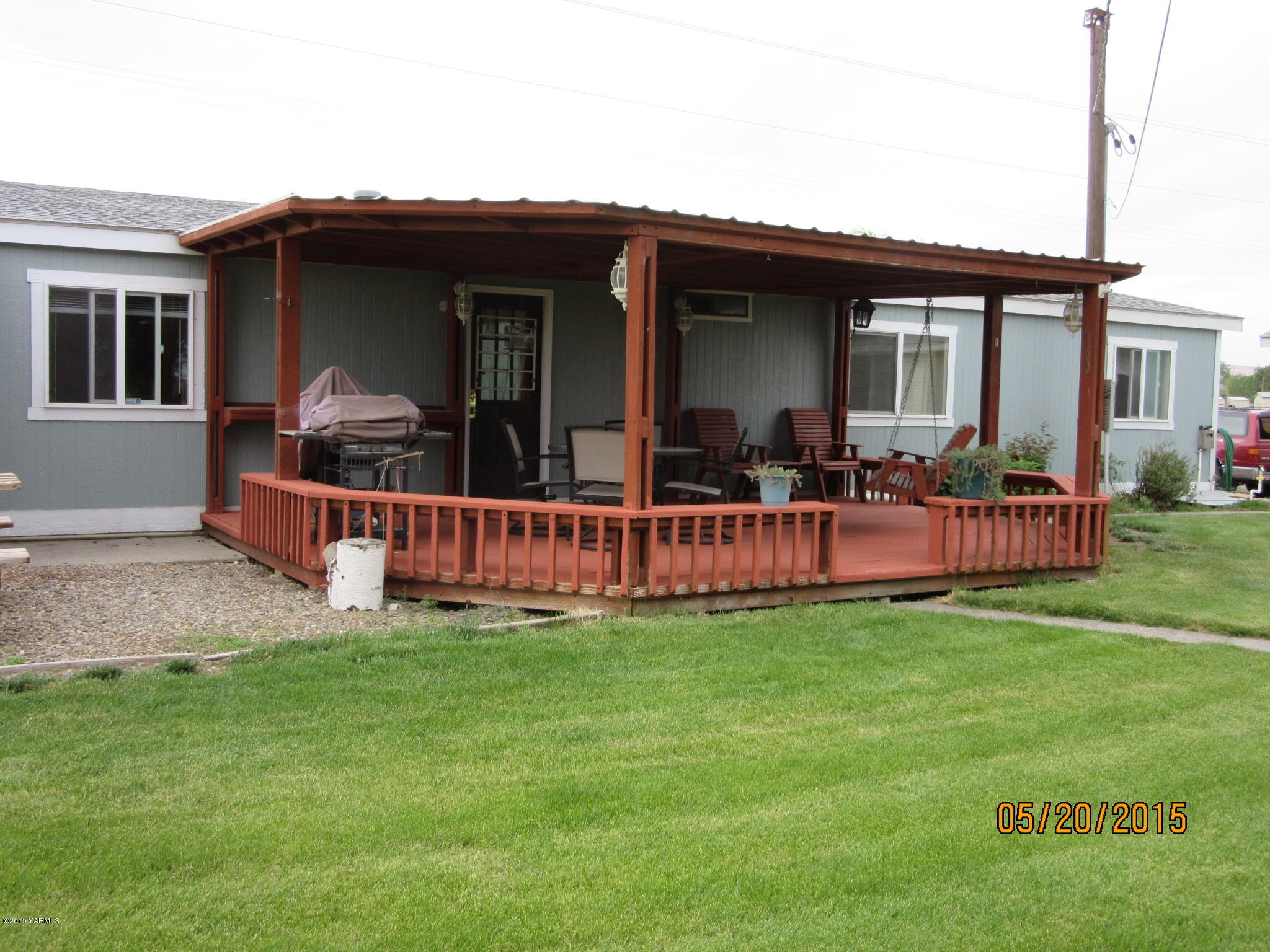 1510 Gurley Road Granger, WA 98932 - Photo 7 of 29 a view of a house with a yard and deck