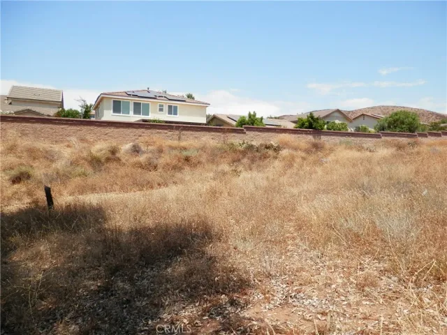 a view of a house with a mountain and a forest