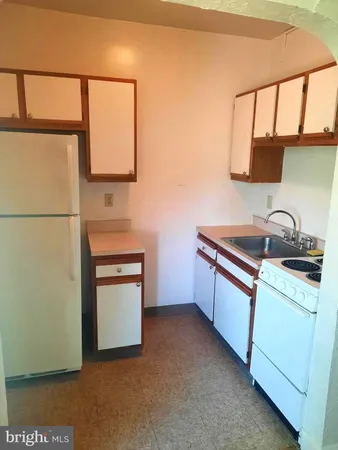a kitchen with a sink cabinets and a window
