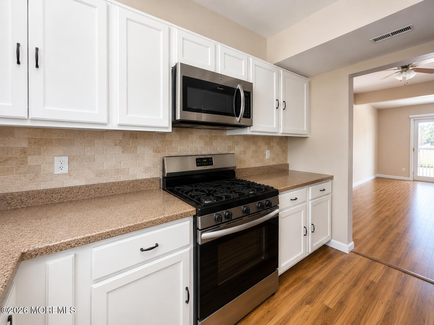 1 Max Place Howell, NJ 07731 - Photo 8 of 16 a kitchen with granite countertop white cabinets and stainless steel appliances