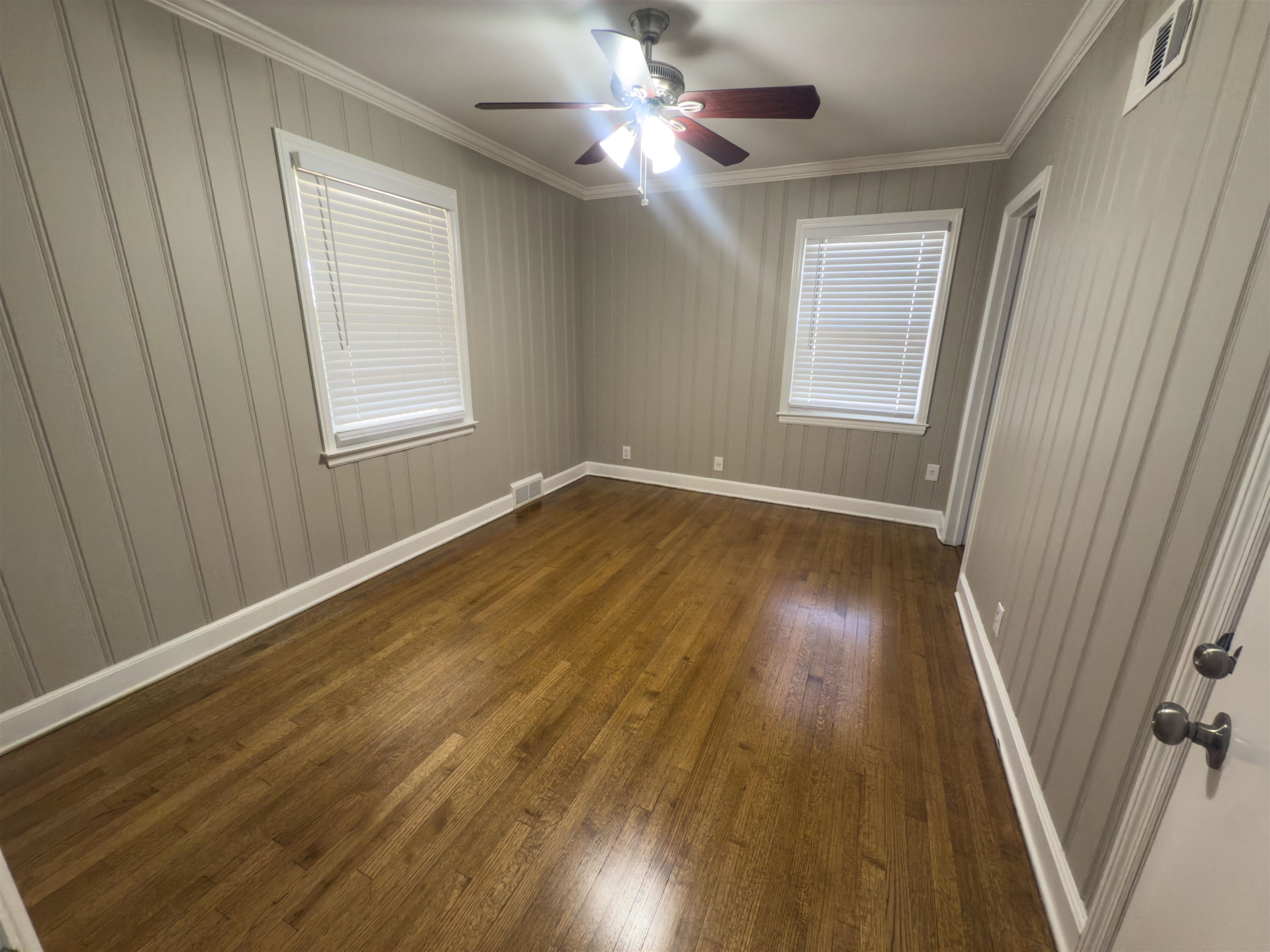 1050 Marcia Road Memphis, TN 38117 - Photo 12 of 20 a view of empty room with wooden floor and fan