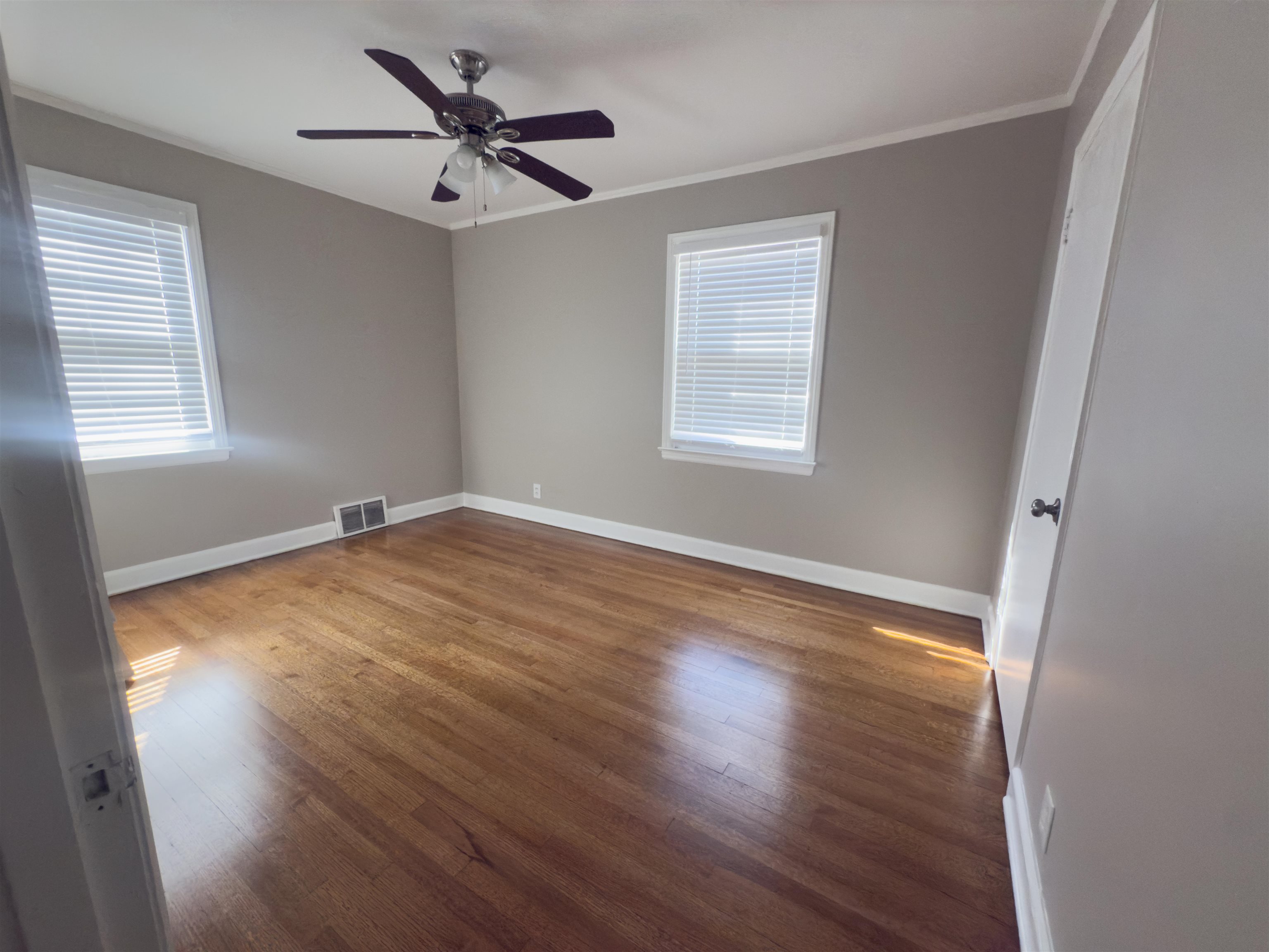 1050 Marcia Road Memphis, TN 38117 - Photo 14 of 20 a view of empty room with wooden floor and fan
