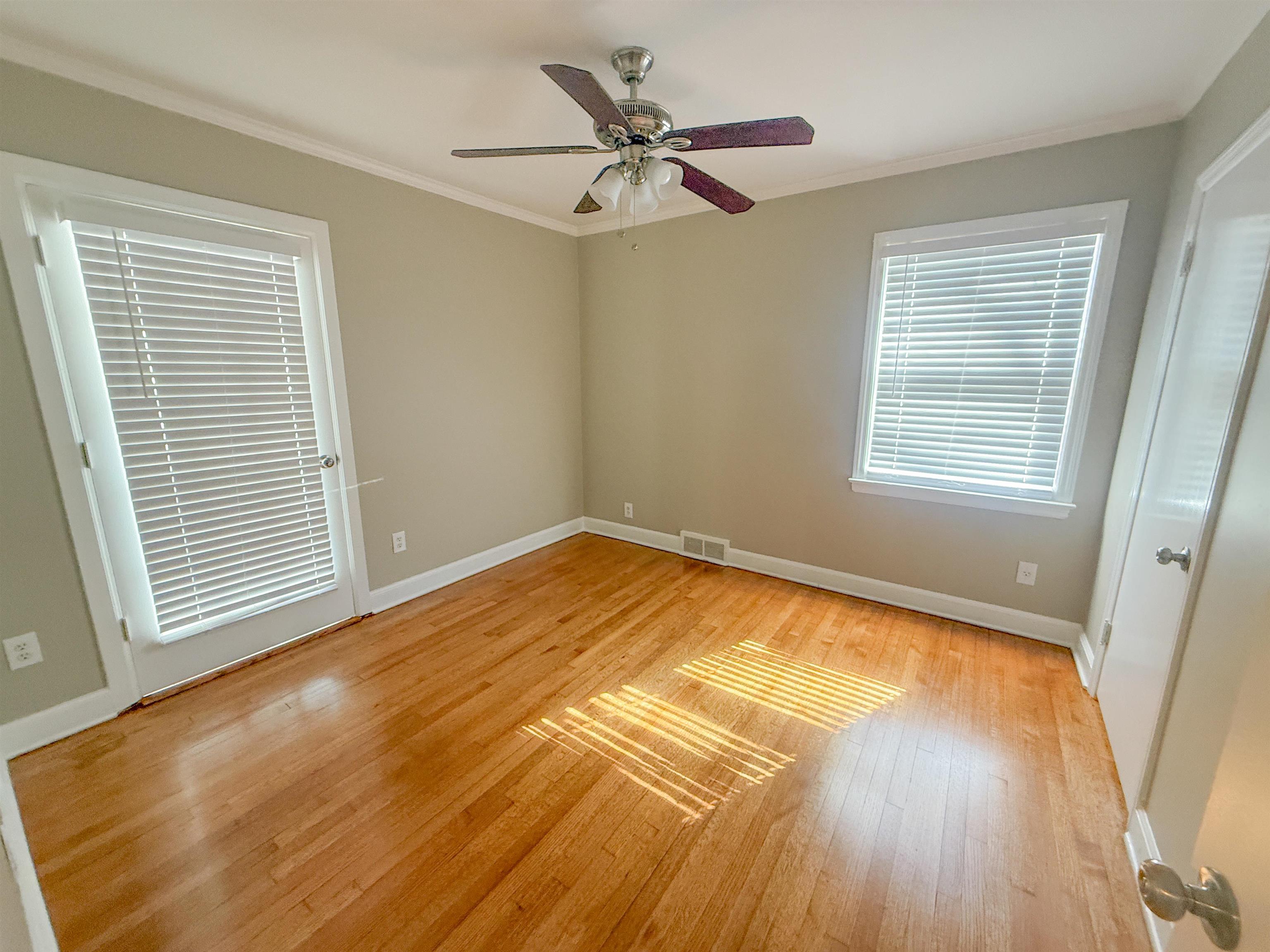 1050 Marcia Road Memphis, TN 38117 - Photo 15 of 20 a view of an empty room with a window and wooden floor