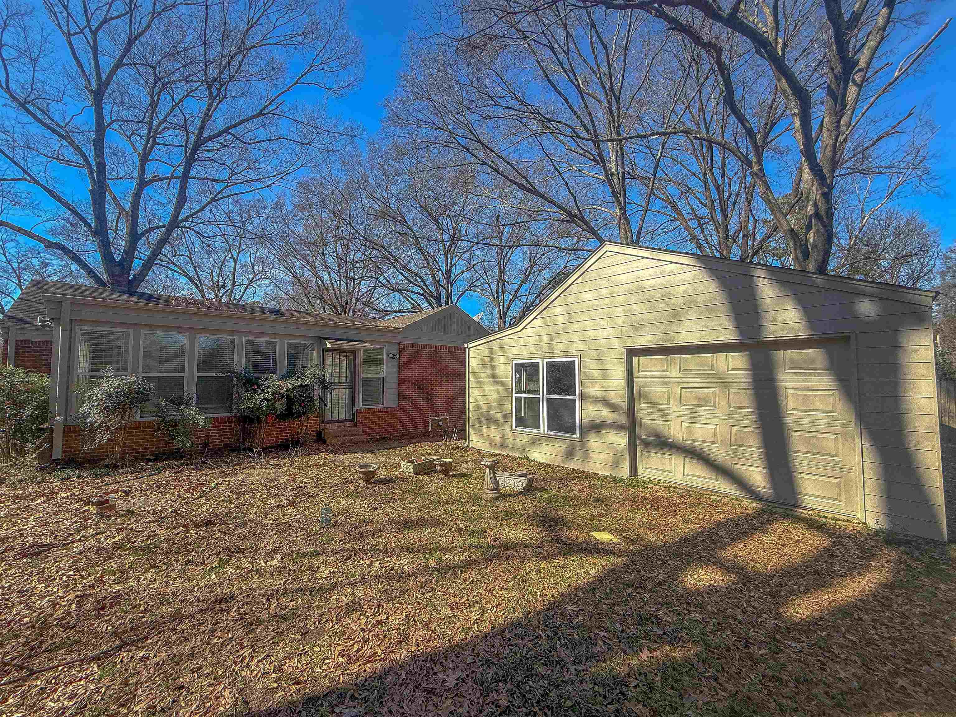 1050 Marcia Road Memphis, TN 38117 - Photo 16 of 20 a view of a house with a large tree and wooden fence