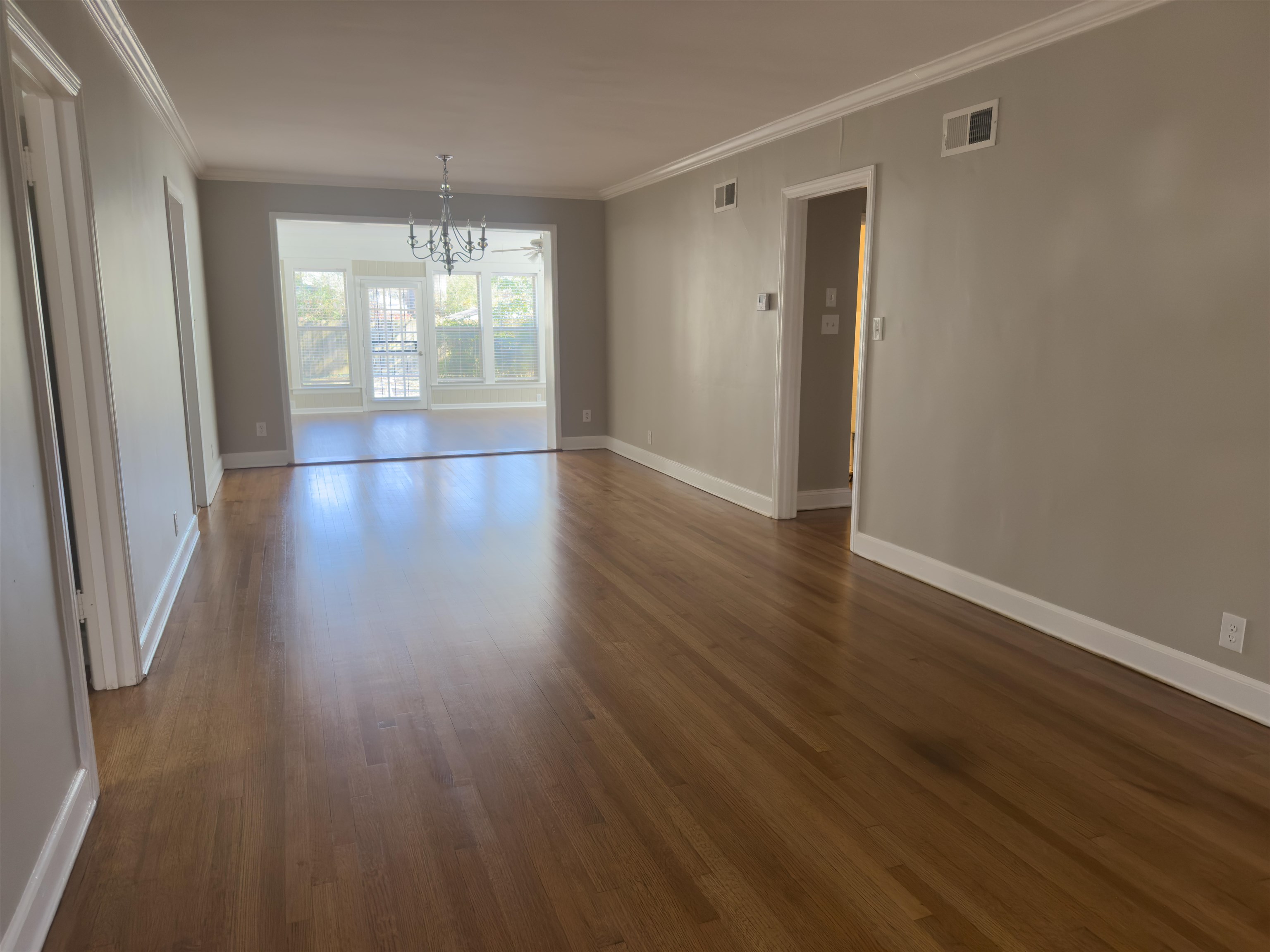1050 Marcia Road Memphis, TN 38117 - Photo 19 of 20 an empty room with wooden floor and windows