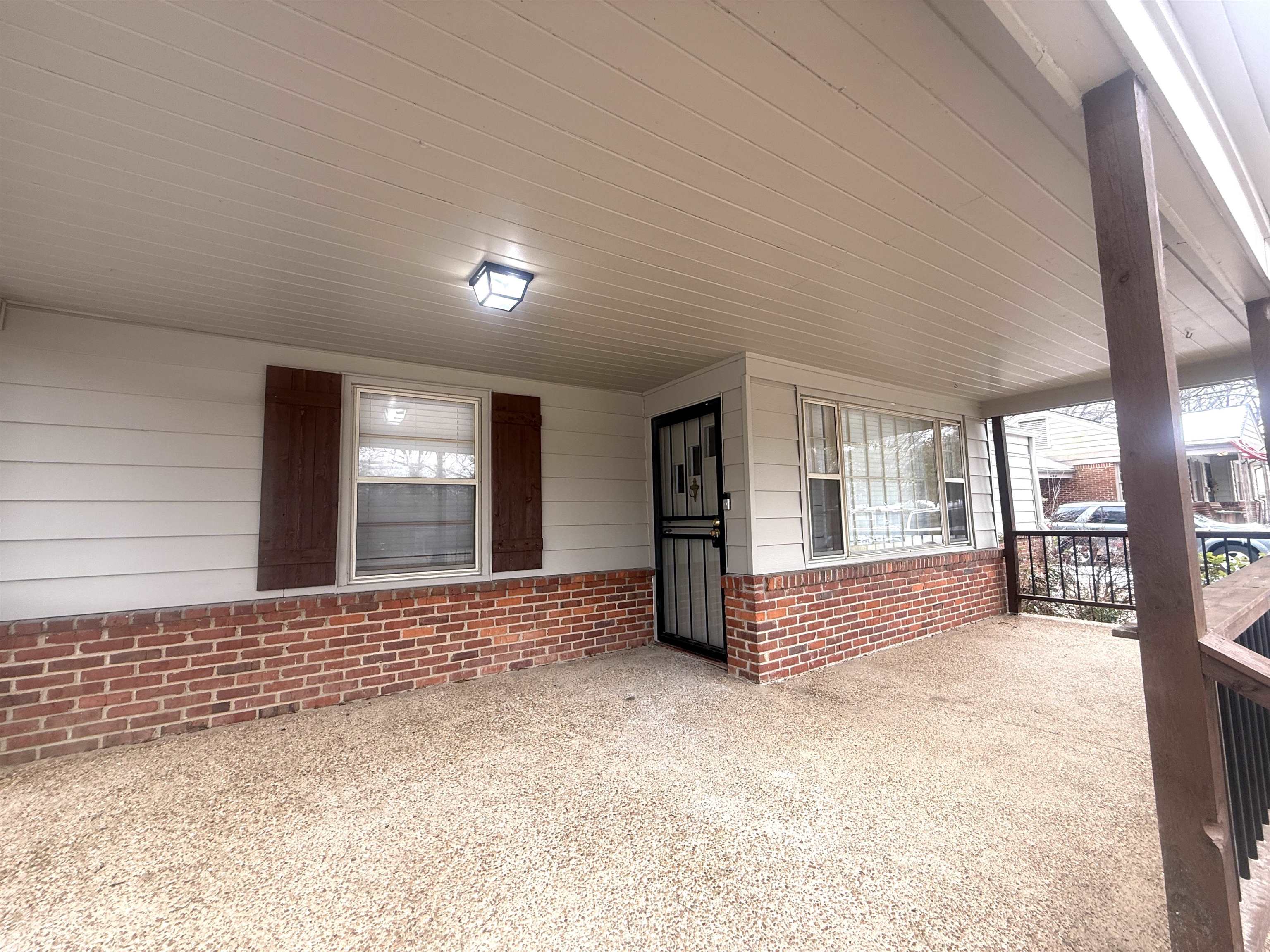 1050 Marcia Road Memphis, TN 38117 - Photo 2 of 20 a view of an empty room with a fireplace and a large window