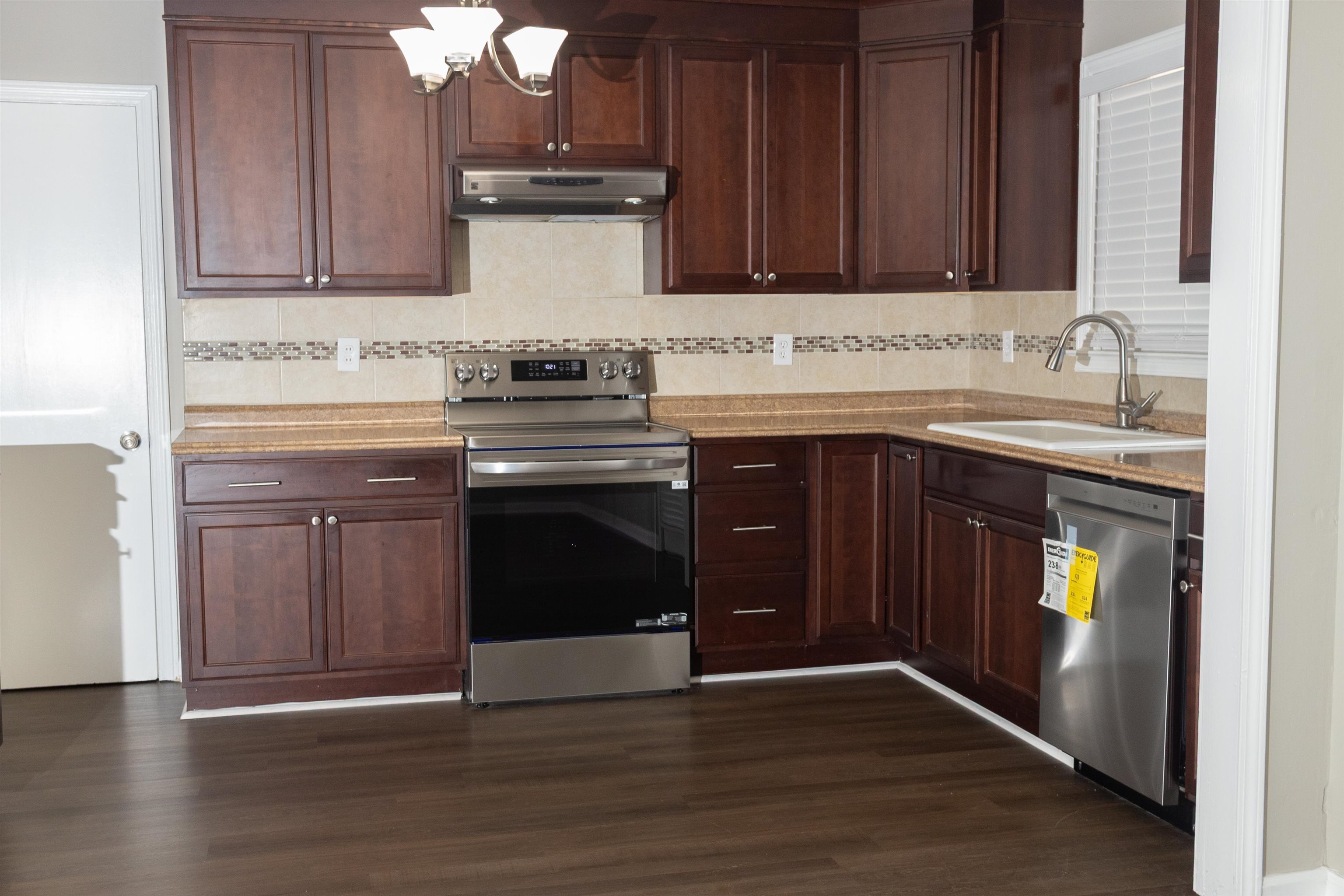 1050 Marcia Road Memphis, TN 38117 - Photo 8 of 20 a kitchen with granite countertop wooden cabinets and a sink