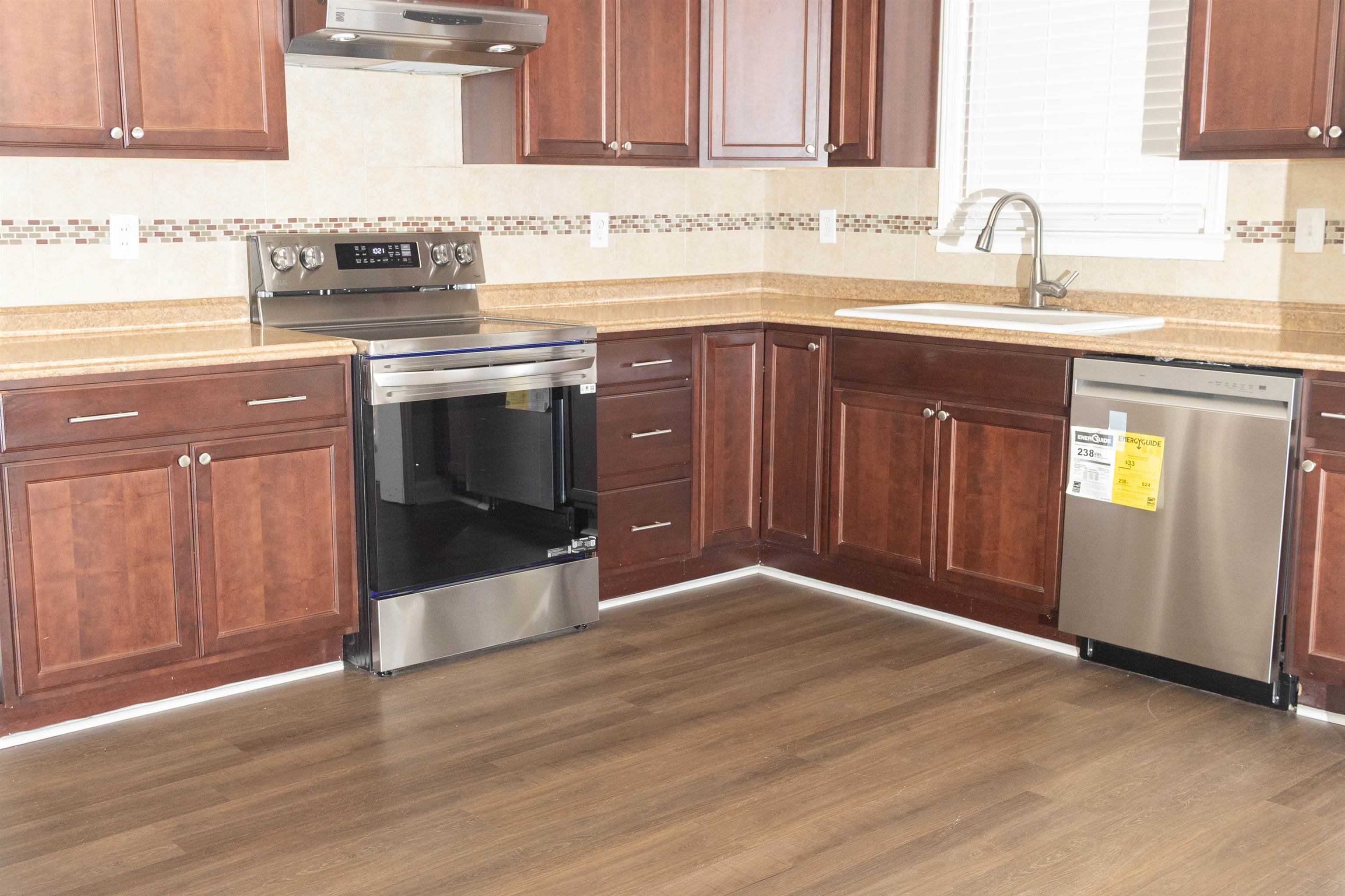 1050 Marcia Road Memphis, TN 38117 - Photo 9 of 20 a kitchen with granite countertop wooden cabinets and a sink