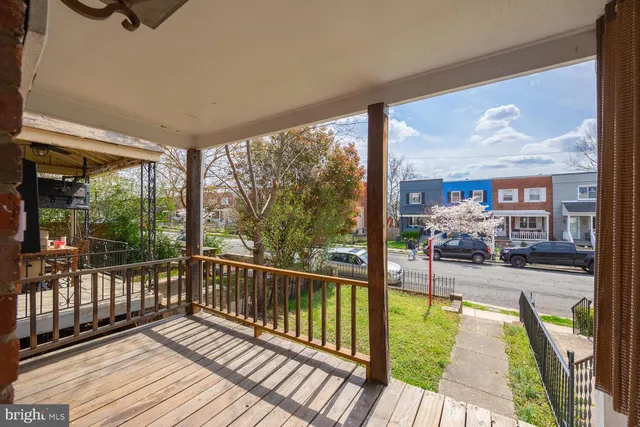 a view of a balcony with floor to ceiling windows with wooden floor