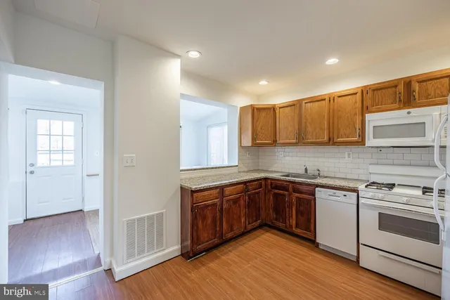 a kitchen with stainless steel appliances granite countertop wooden cabinets and a granite counter tops